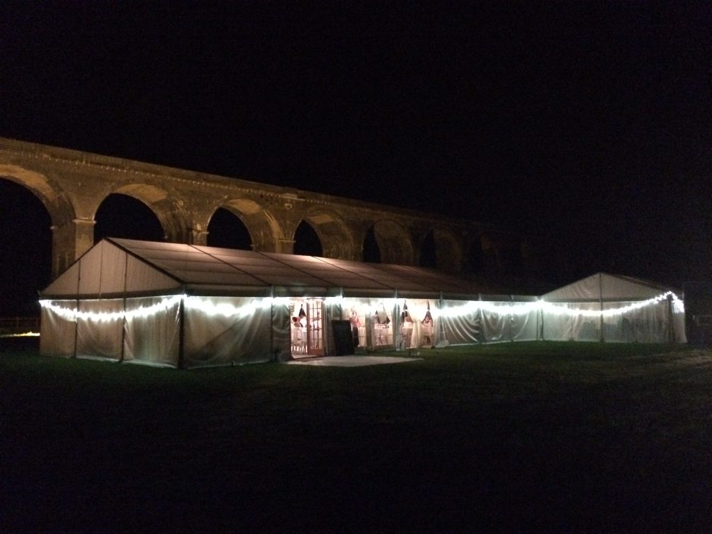 Marquee under the lit viaduct